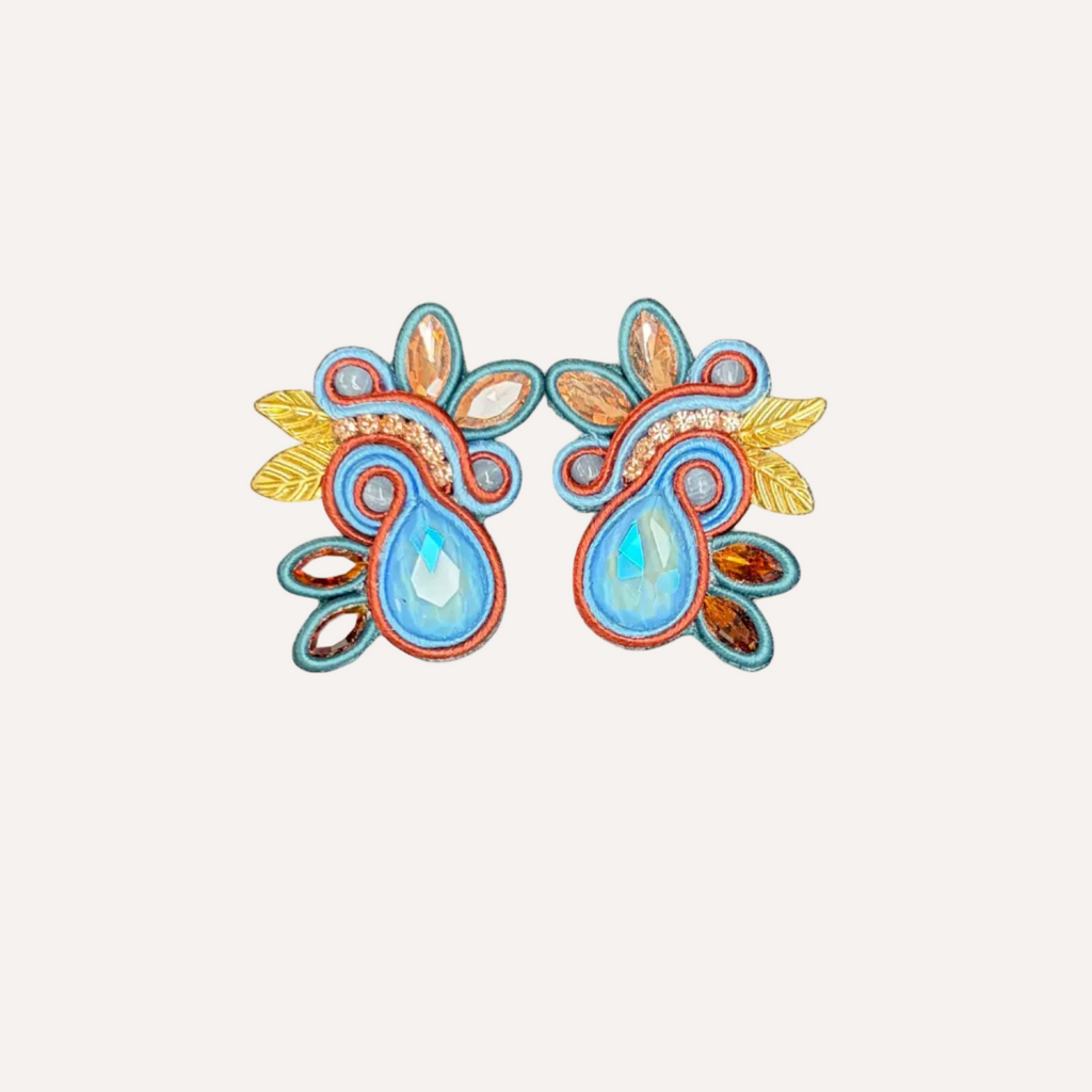 Colorful floral earrings on a white background